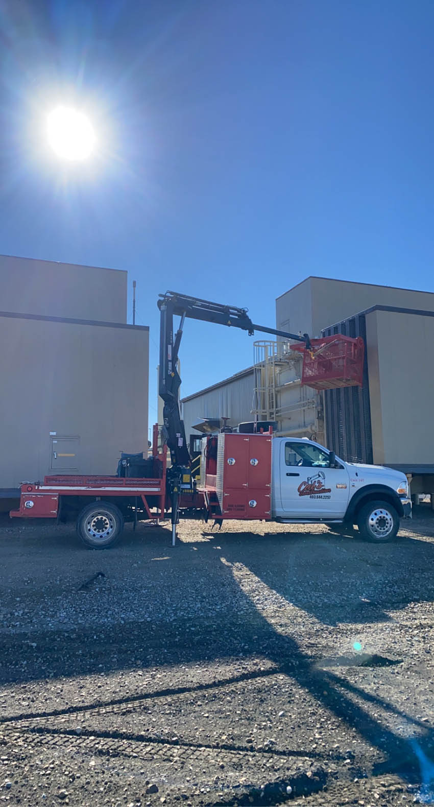 A crane stands parked in front of a building, showcasing construction activity in an urban environment.
